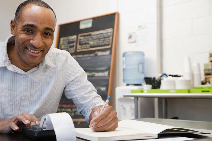 Black business owner doing his taxes at a table
