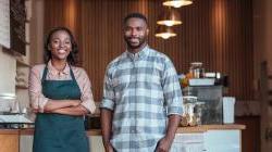Pair of black entrepreneurs in their bakery.