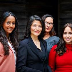 four hispanic business women standing together 